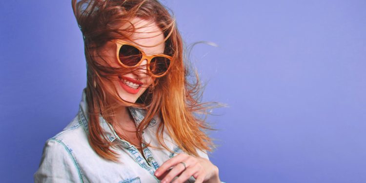 Mysterious Woman Smiling using sunglasses